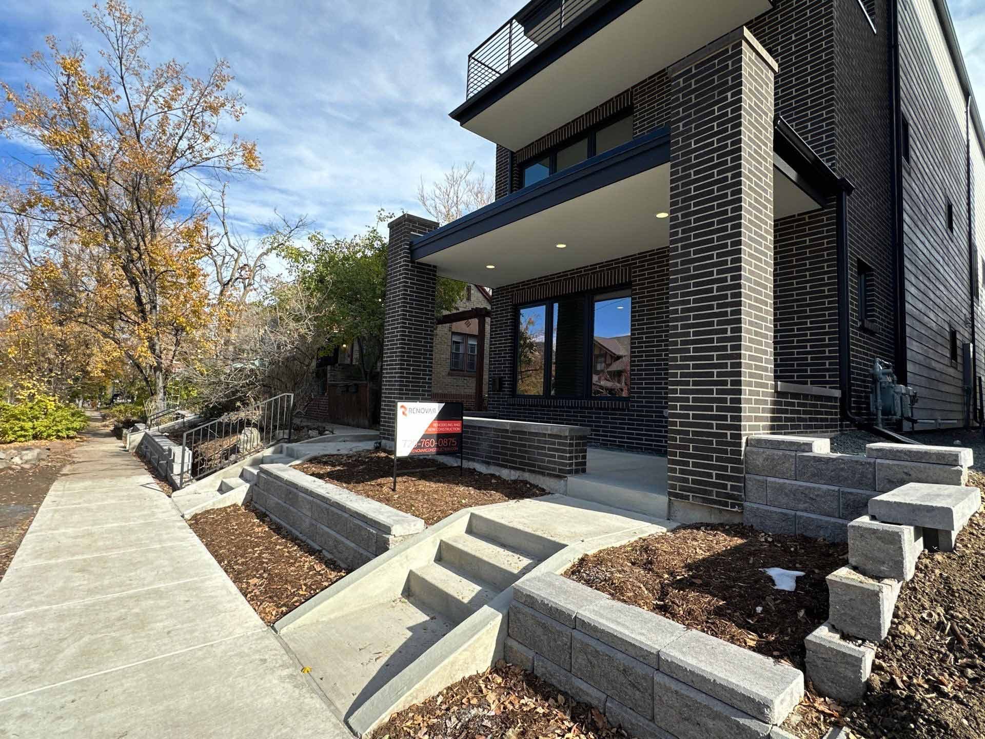 A dark-brick modern custom home built by Renovar on Josephine Street, Denver