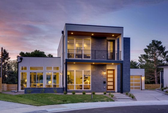 Daylight exterior of the E Bails Drive home showing its angled roofline and glass entry